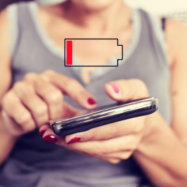 woman with a smartphone with low battery