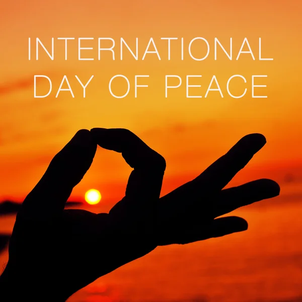 Hands in gyan mudra and text international day of peace — ストック写真