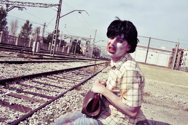 Scary zombie man waiting for the train — Stock Photo, Image