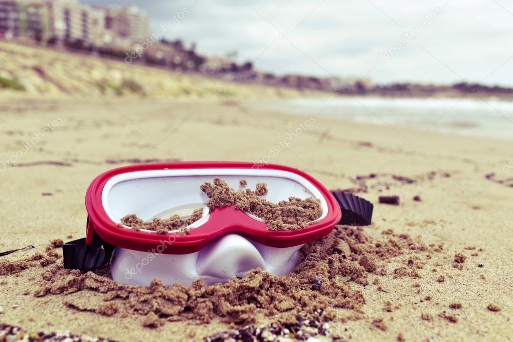 Abandoned diving mask on the beach