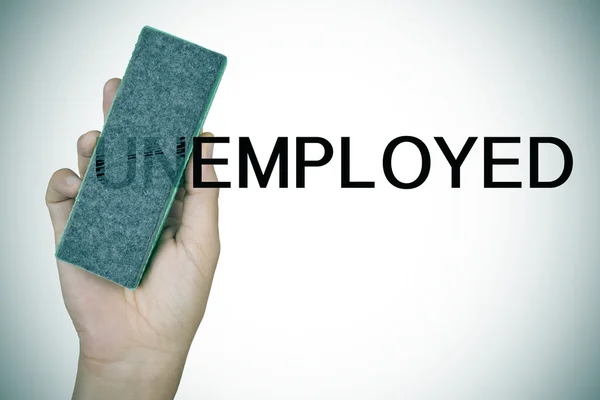 Deleting the prefix UN in the word unemployed with an eraser — Stock Photo, Image