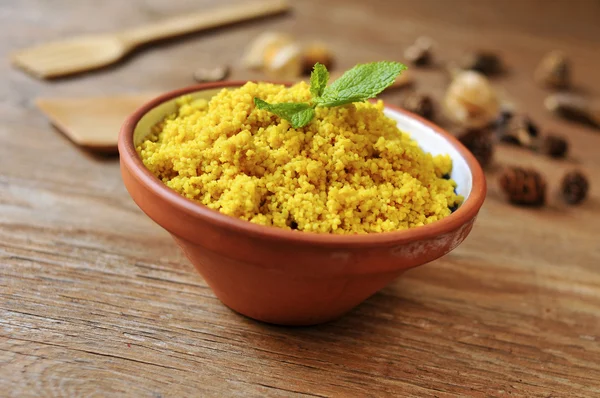 Spiced couscous on a rustic wooden table — Stock Photo, Image