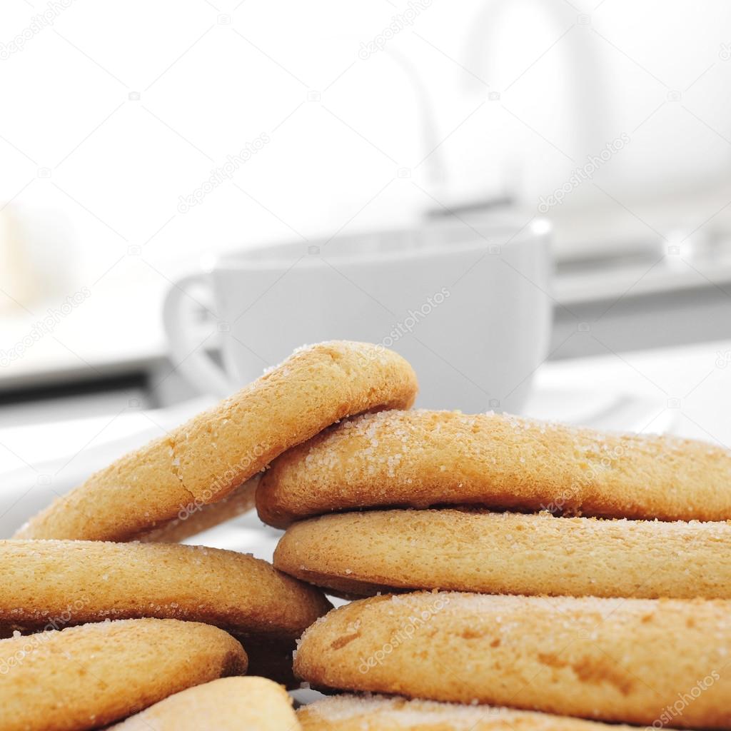 ladyfingers and a cup of coffee or tea on the kitchen table