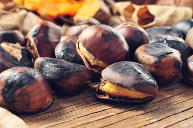 roasted chestnuts on a rustic wooden table clipart