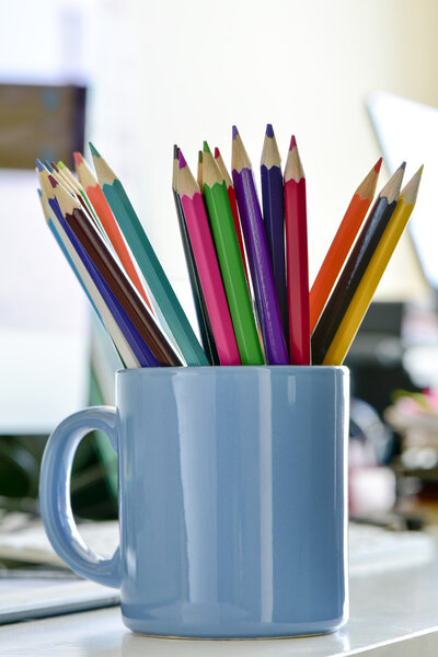 coloured pencils in a mug