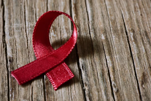 Red ribbon for the fight against AIDS — Stock Photo, Image