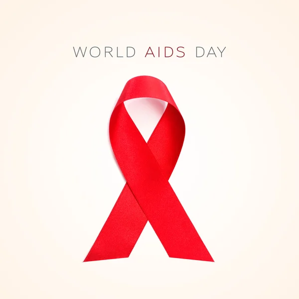 Piros szalag és a szöveg az Aids világnapja — Stock Fotó