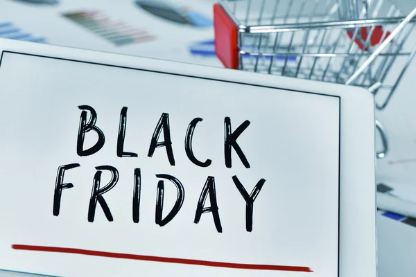 Text black friday in a tablet and a shopping cart — Stock Photo, Image
