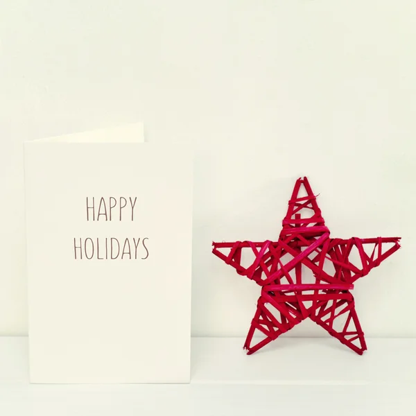 Estrella de Navidad y texto felices fiestas — Foto de Stock