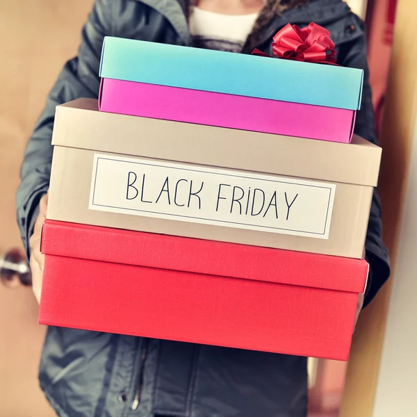 Man with boxes with the text happy black friday — Stock Photo, Image