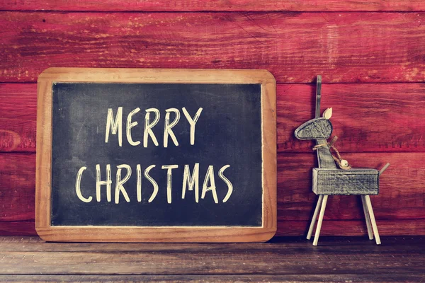 Ren geyiği ve metin yazı tahtası içinde mutlu Noeller — Stok fotoğraf