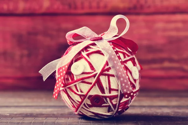 Christmas ball ornamented with ribbons and buttons — Stock Photo, Image