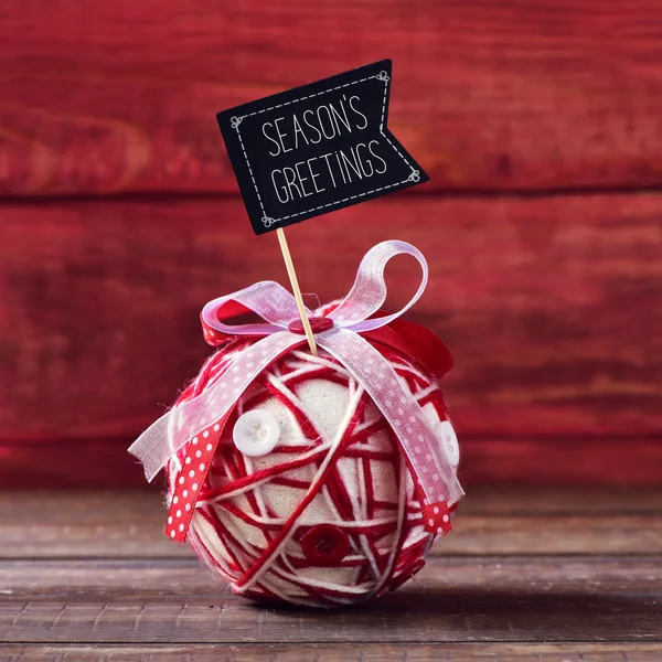 Christmas ball and text seasons greetings — Stock Photo, Image