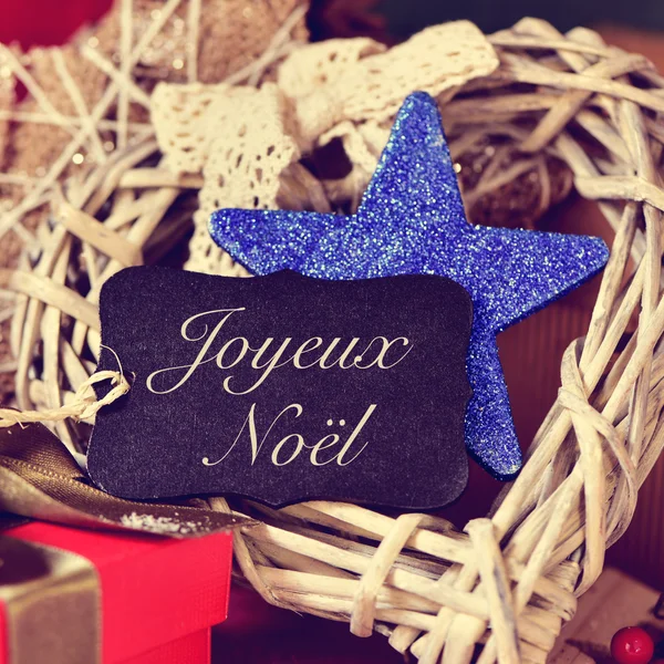 Ornaments and text joyeux noel, merry christmas in french — Stock Photo, Image