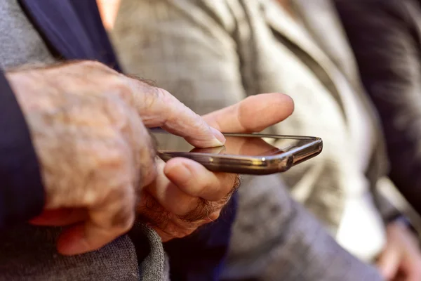 Anciano usando un teléfono inteligente — Foto de Stock