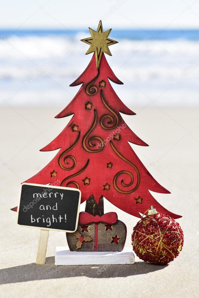 christmas tree and text merry and bright on the beach