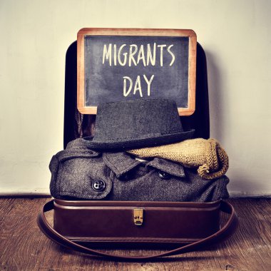 old suitcase with some clothing and chalkboard with text migrant clipart