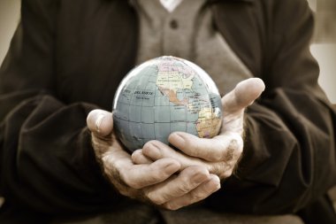 old man with a world globe in his hands clipart