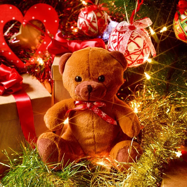 Teddy bear and gifts under a christmas tree Stock Photo