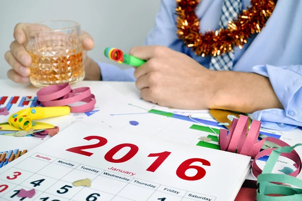 Businessman drinking in the office during a new years party — Stock Photo, Image