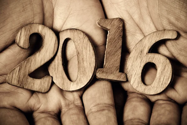 Number 2016, as the new year, in the hands of a man — Stock Photo, Image