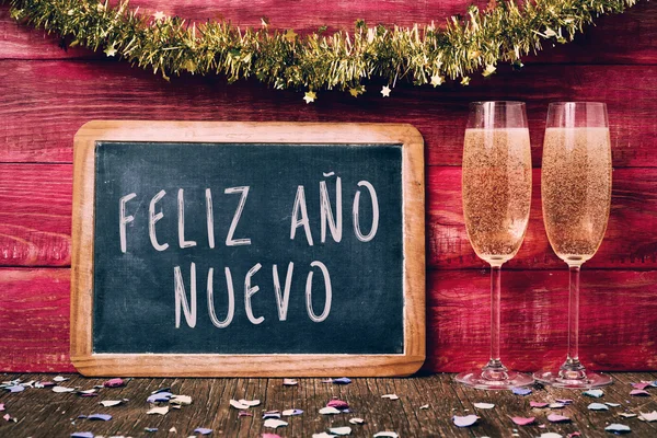 Champagner und Text feliz ano nuevo, frohes neues Jahr auf spanisch — Stockfoto