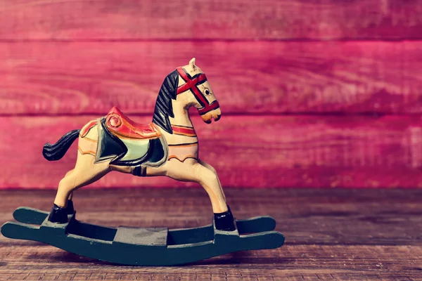 Old toy horse on a wooden surface — Stock Photo, Image