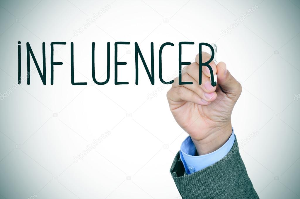 man writing the word influencer