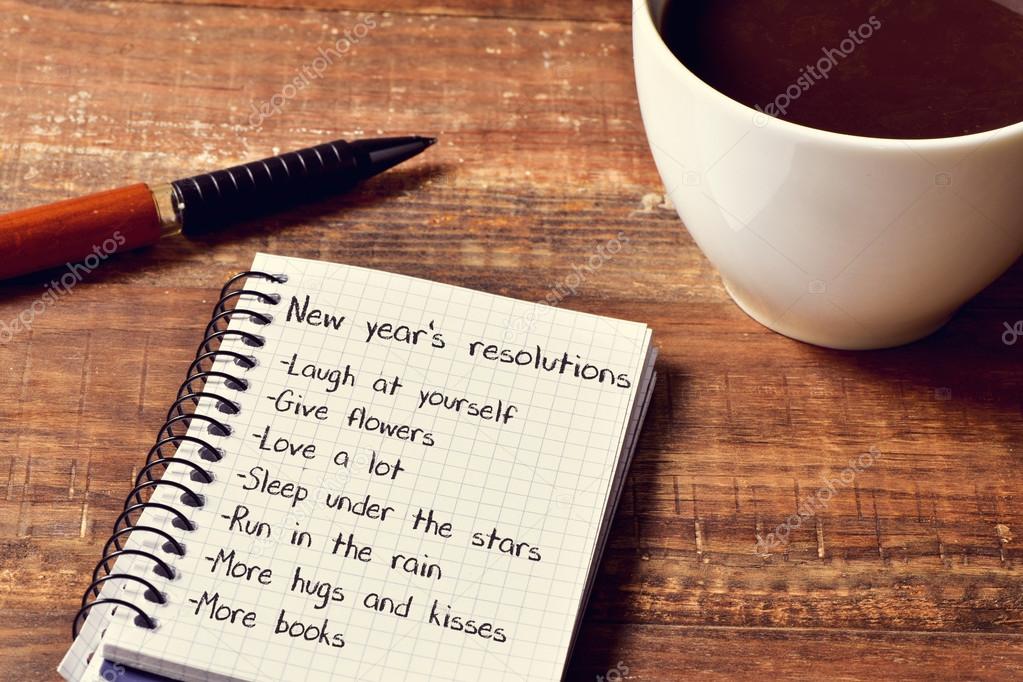 coffee and notepad with a list of new years resolutions