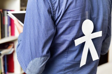 young man with a paper man attached in his back clipart