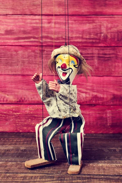 Old marionette on a wooden surface — Stock Photo, Image
