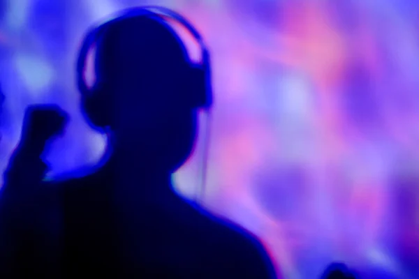 Young man with headphones in a dance club — Stock Photo, Image