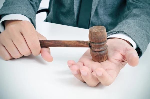 Man with a gavel in his hand — Stock Photo, Image