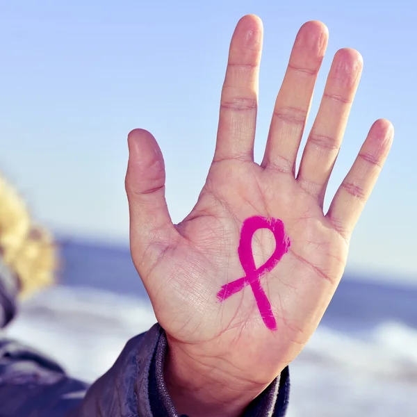 Young man with a pink ribbon for the fight against cancer — Stock Photo, Image