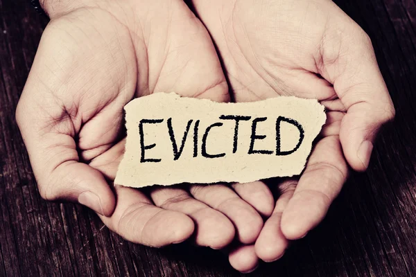 Man with a piece of paper with the word evicted — Stock Photo, Image