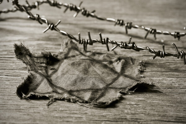 Jewish badge and barbed wire, in sepia toning