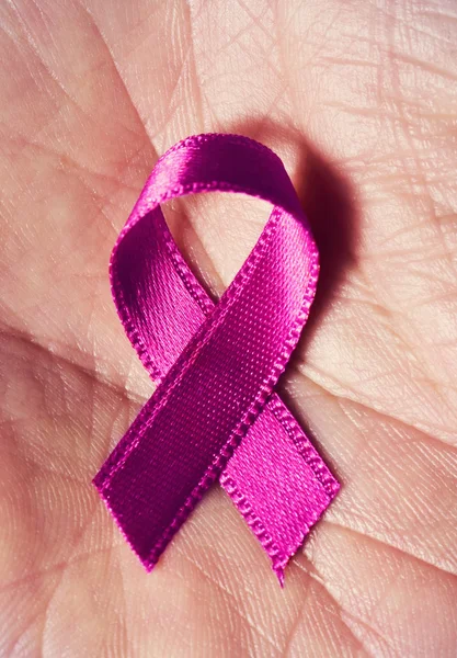 A pink ribbon in the hand of a man — Stock Photo, Image