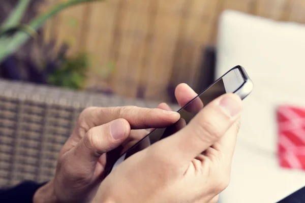 Young man using a smartphone — Stock Photo, Image