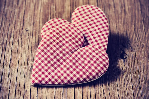 Hearts on a rustic wooden surface — Stock Photo, Image
