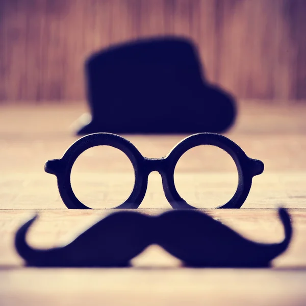 Mustache, eyeglasses and hat forming the face of a man — Stock Photo, Image