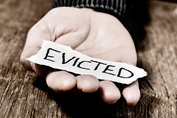 Man with a piece of paper with the word evicted — Stock Photo, Image