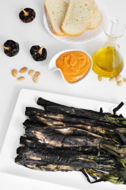 barbecued calcots, sweet onions, and romesco sauce clipart