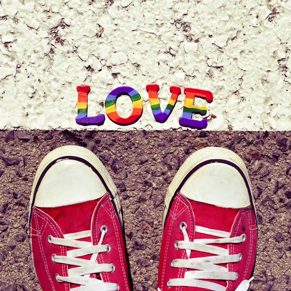 Man stepping on the asphalt and the word love — Stock Photo, Image