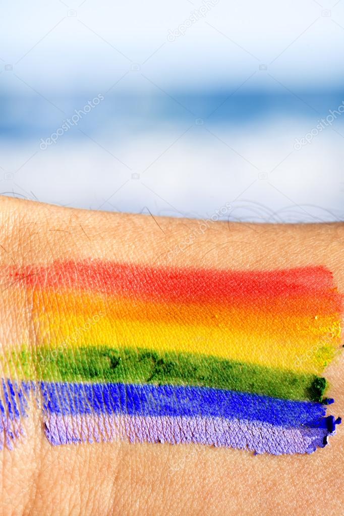 man with a rainbow flag painted in his wrist