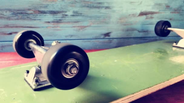 Cinemagraph of the wheels of a skateboard spinning — Stock Video