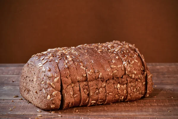 Szeletelt rozskenyér, fa felületre — Stock Fotó