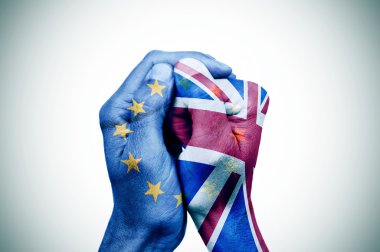 hands patterned with the European and the British flag clipart