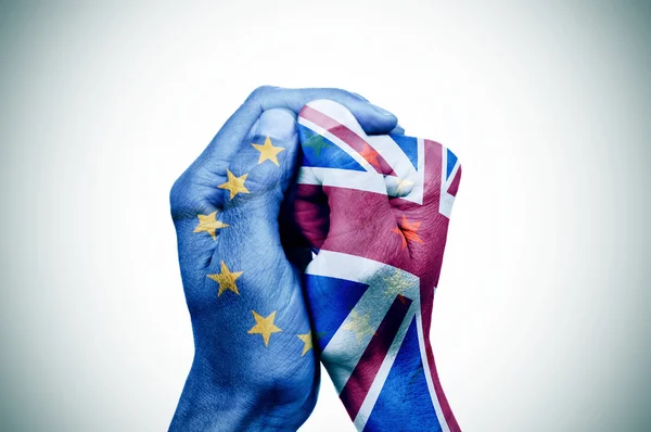 Hands patterned with the European and the British flag — Stock Photo, Image