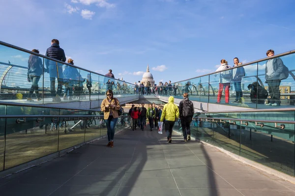 La gente cammina attraverso il Millennium Bridge . — Foto Stock