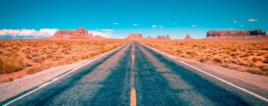 Desert highway leading into Monument Valley, Utah, USA clipart